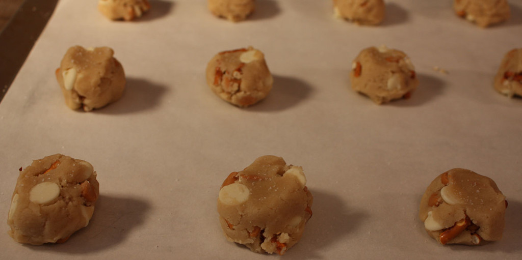 Butterscotch Pretzel Chip Cookies - Oh my, are these cookies addictive! Satisfy your salty-sweet obsession with these perfectly crunchy cookies! Cookie dough balls on a parchment paper lined baking sheet