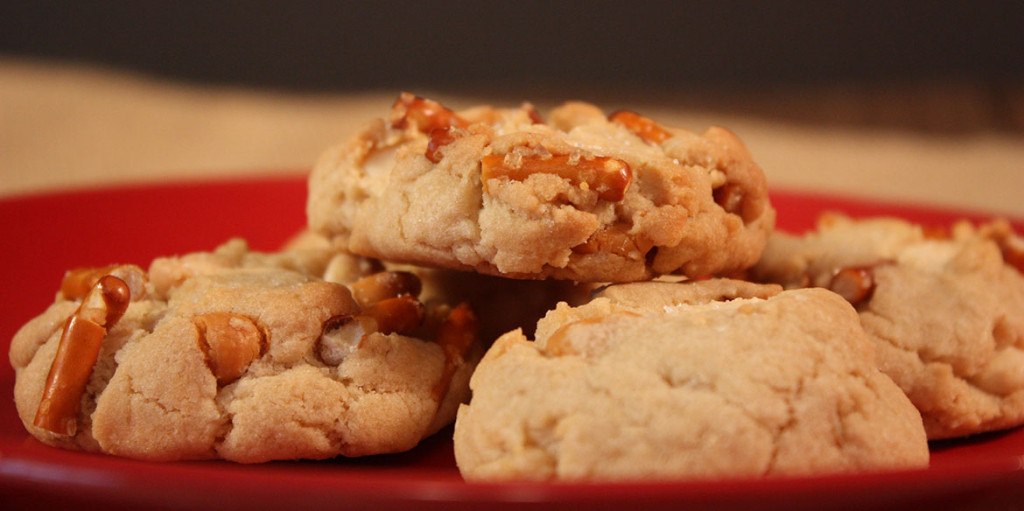 Butterscotch Pretzel Chip Cookies - Oh my, are these cookies addictive! Satisfy your salty-sweet obsession with these perfectly crunchy cookies! Salted Butterscotch Pretzel Cookies stacked on a red plate