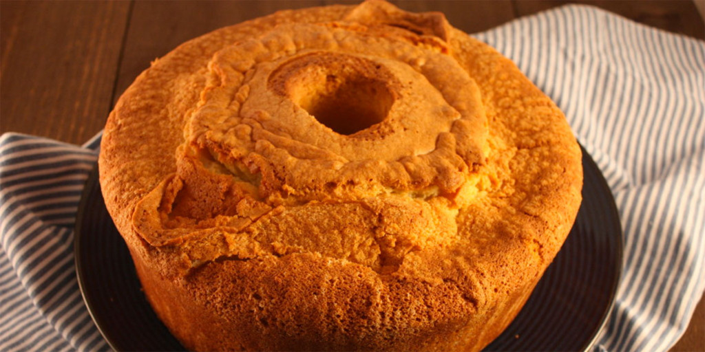 Mom's Sour Cream Pound Cake - Moist, tender inside with a crispy crunchy crust. A classic at it's best! Sour Cream Pound Cake on a black plate.