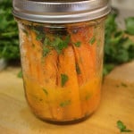 Marinated carrot sticks in a mason jar.