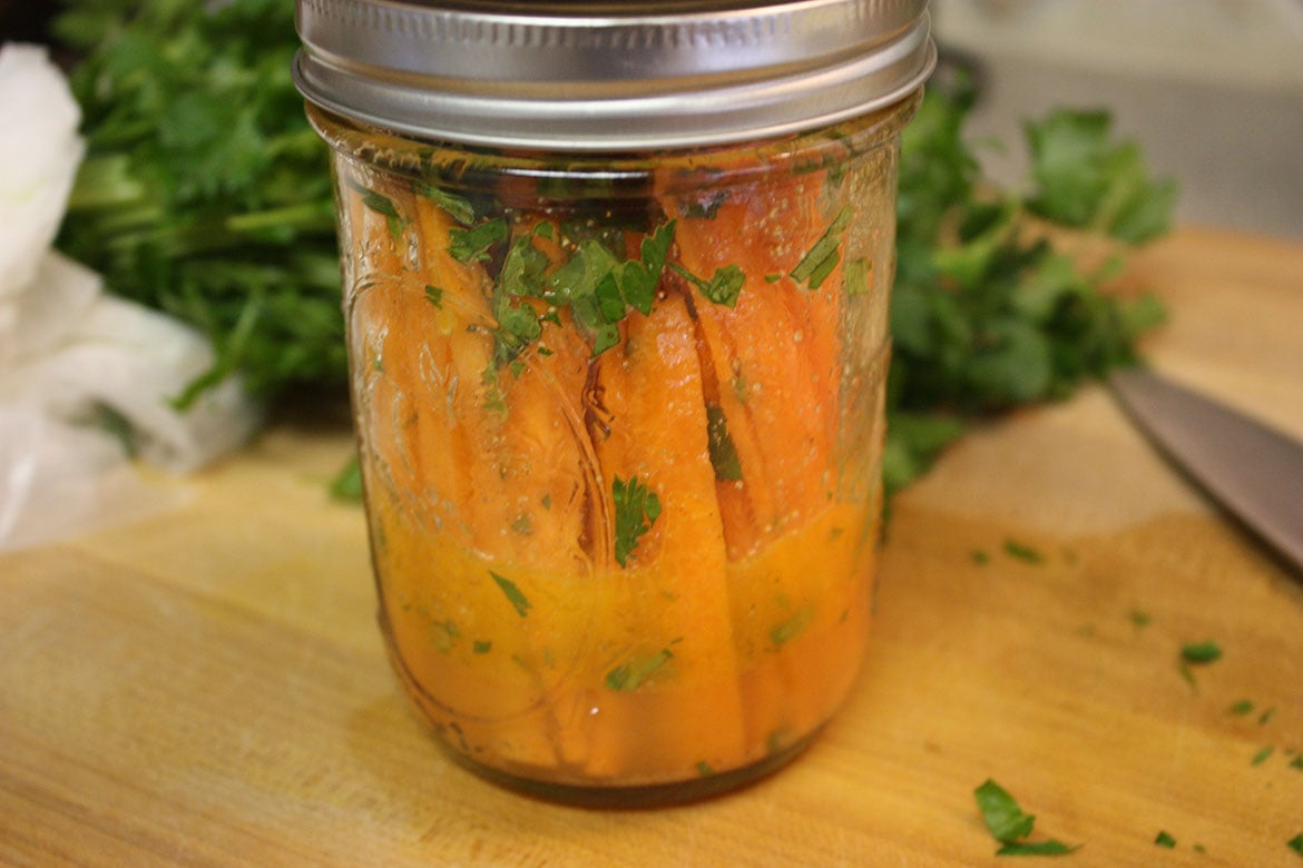 Marinated carrot sticks in a mason jar.