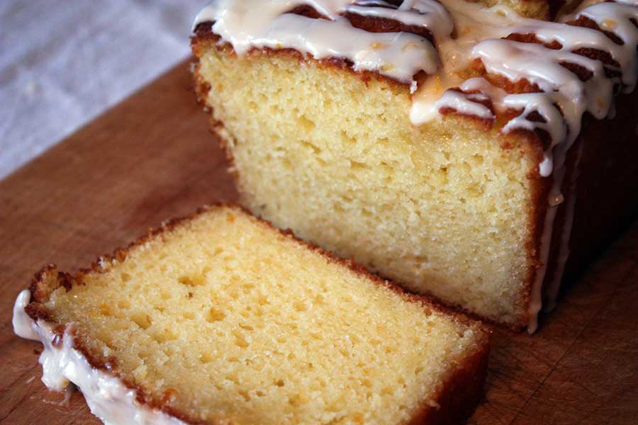 Meyer Lemon Loaf sliced on a wooden board