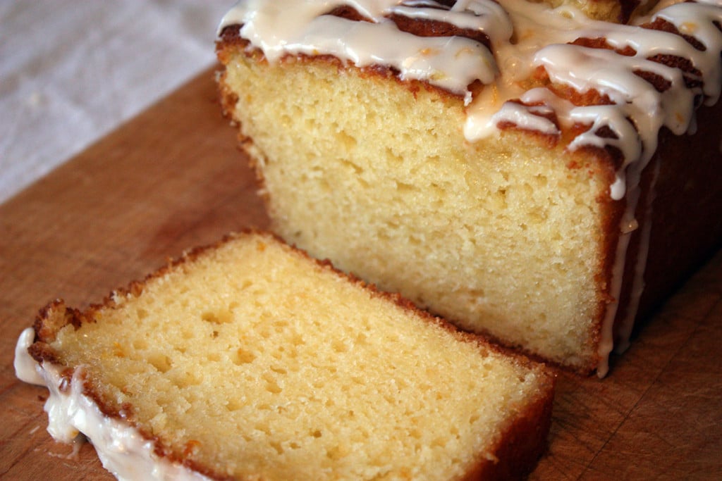 Meyer Lemon Loaf  with a slice cut on a wooden cutting board.