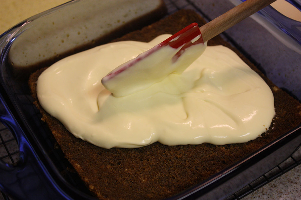 Cake with half the mascarpone mixture spread on top.