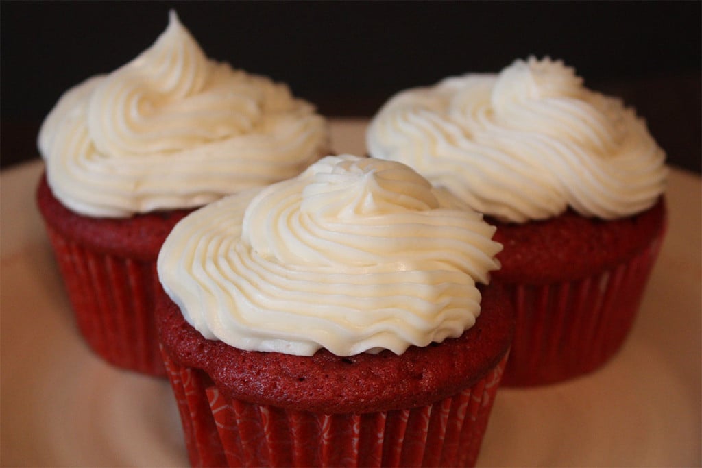 Red Velvet Cupcakes with cream cheese frosting on a white plate.
