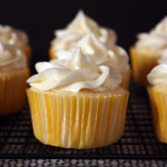 Lemon cupcakes on a wire rack.