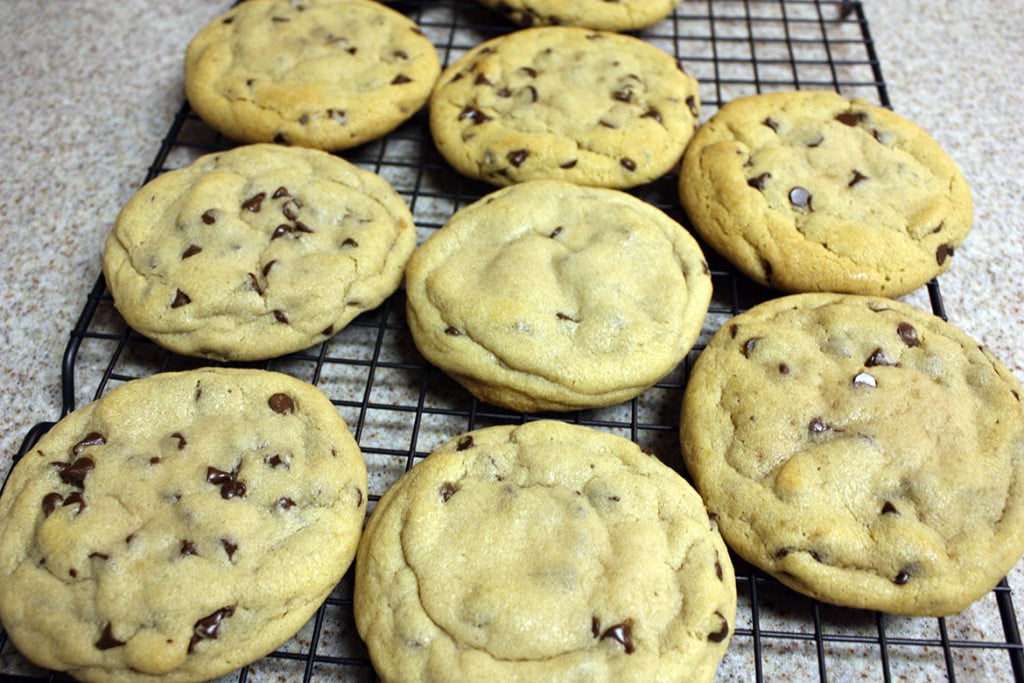 Chocolate chip cookies on a wire rack.