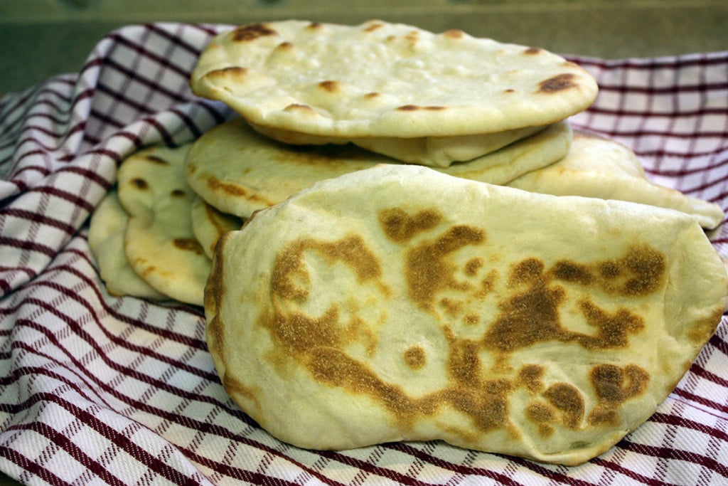 Homemade Naan Flatbread on a red and white striped towel