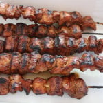 Filipino Pork Kebabs (Pinoy) skewers on a white plate.