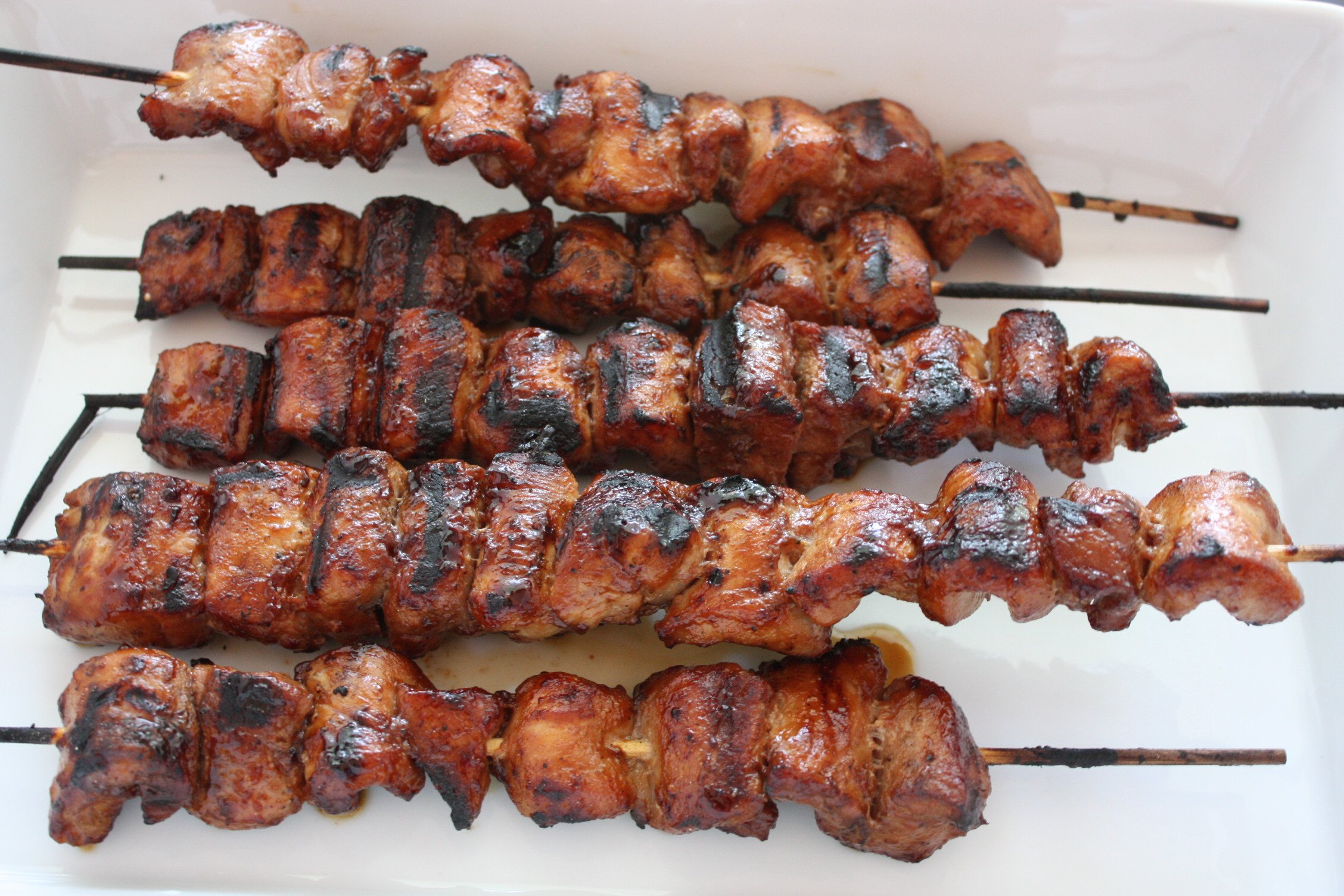 Filipino Pork Kebabs (Pinoy) skewers on a white plate.