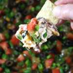 Black Bean Taco Dip on a tortilla strip.