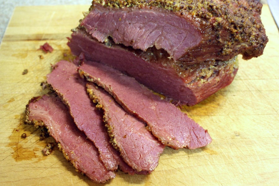 Corned Beef, sliced on a cutting board.