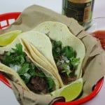 Carne Asada Street Tacos in a red basket.