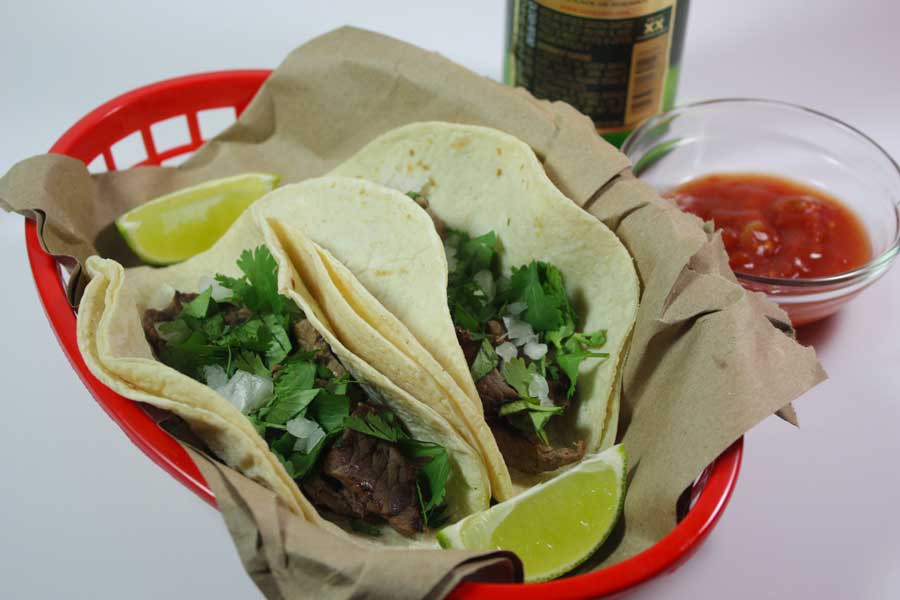 Carne Asada Street Tacos in a red basket.