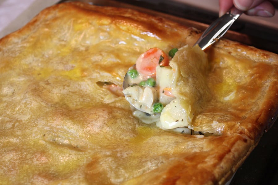 Chicken Pot Pie with the spoon just breaking through the crust.