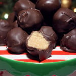 Peanut butter balls stacked on a red and green plate.