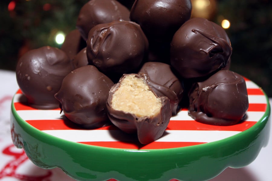 Peanut butter balls stacked on a red and green plate.