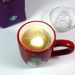 Copycat Holiday Spice Flat White coffee in a Christmas mug.