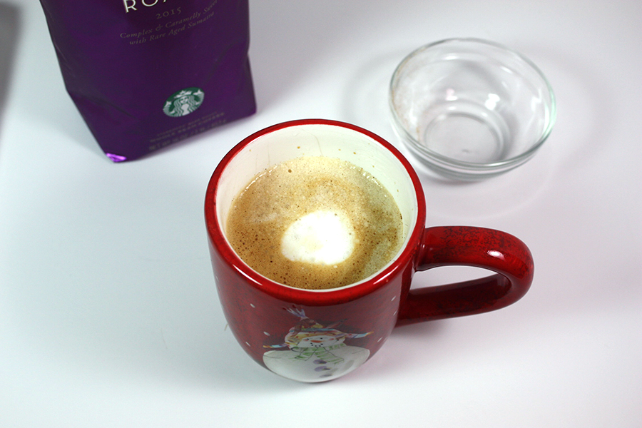 Copycat Holiday Spice Flat White coffee in a Christmas mug.