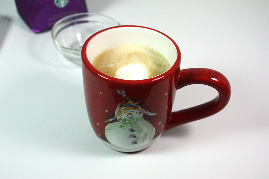 Holiday Spice Flat White in a red Christmas coffee mug