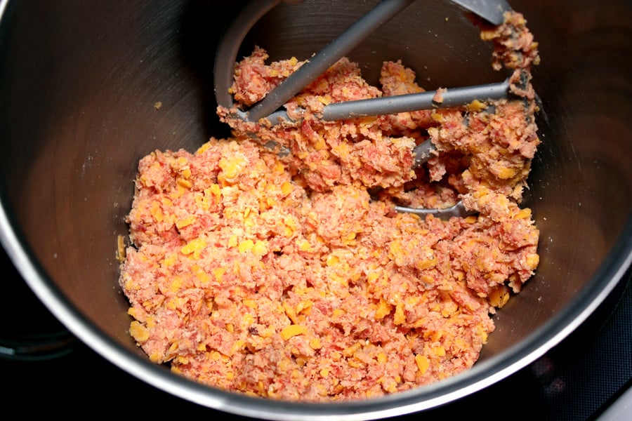 Sausage ball mixture in the bowl of a stand mixer.