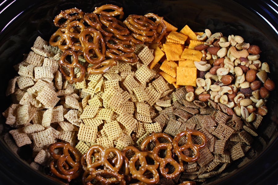 Chex Mix ingredients in the crock of the slow cooker.