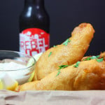 Beer Battered Fish in a basket with a beer in the background.