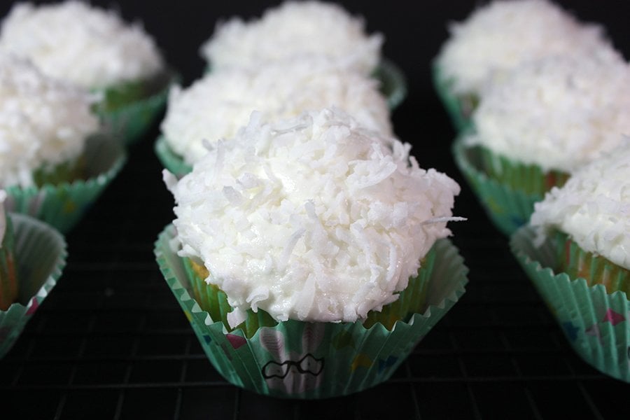 Coconut Cupcakes on a black background.