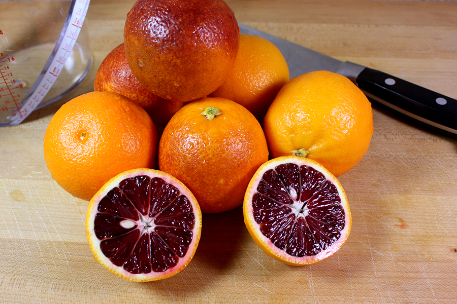 Blood Orange Granita - washed blood oranges on a wooden cutting board