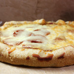 Slow cooker pizza resting on a cutting board.