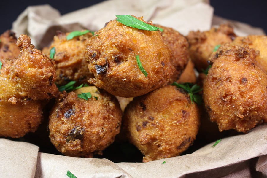 Jalapeno Hushpuppies stacked up in a basket.