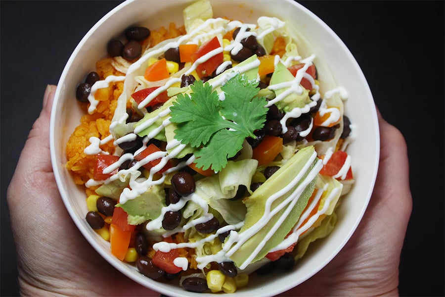 Chicken burrito bowl in a white bowl.