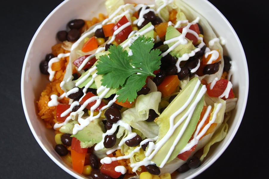 Chicken burrito bowl in a white bowl.