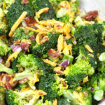 Broccoli salad in a white bowl.