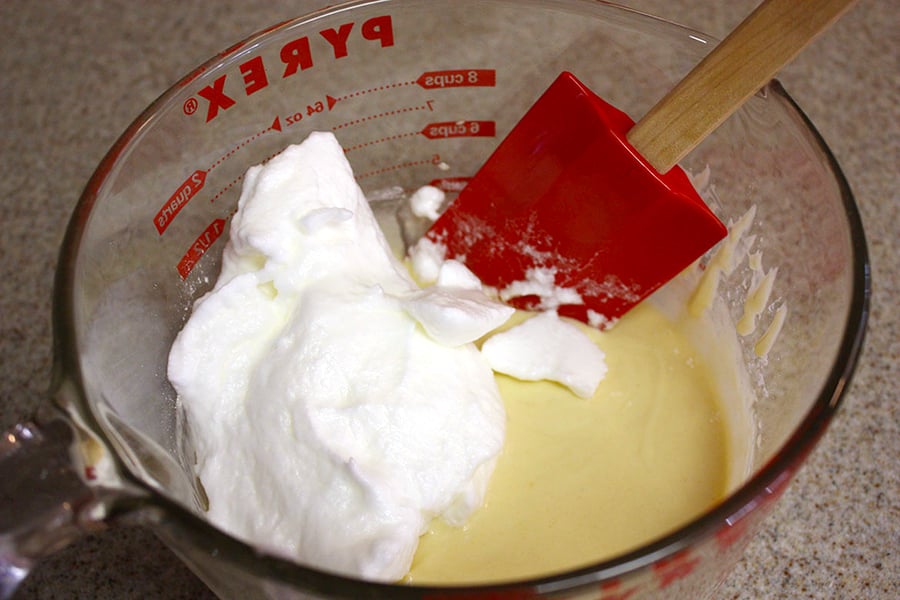 Pancake batter with the whipped egg whites in a glass measuring bowl.