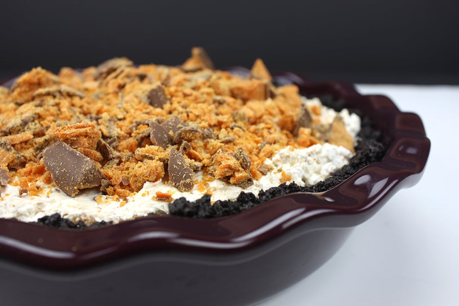 Butterfinger pie in a brown baking dish.