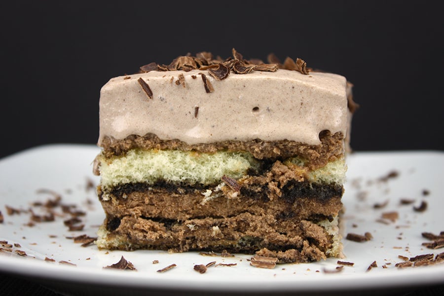 Chocolate Tiramisu on a white plate with a chocolate shaving garnish.
