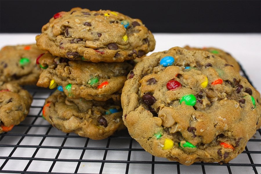 Monster Cookies cooling on a wire rack.