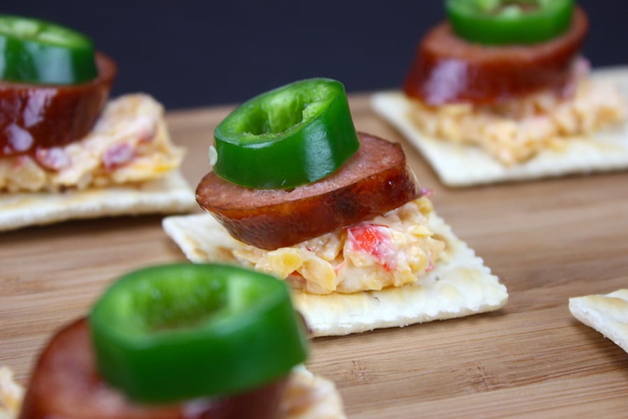 Pimento Cheese on crackers topped with smoked sausage and jalapeno slices.