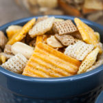 Spicy Cheddar Snack Mix in a blue serving bowl.