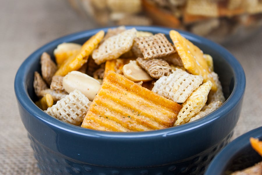 Spicy Cheddar Snack Mix in a blue serving bowl.