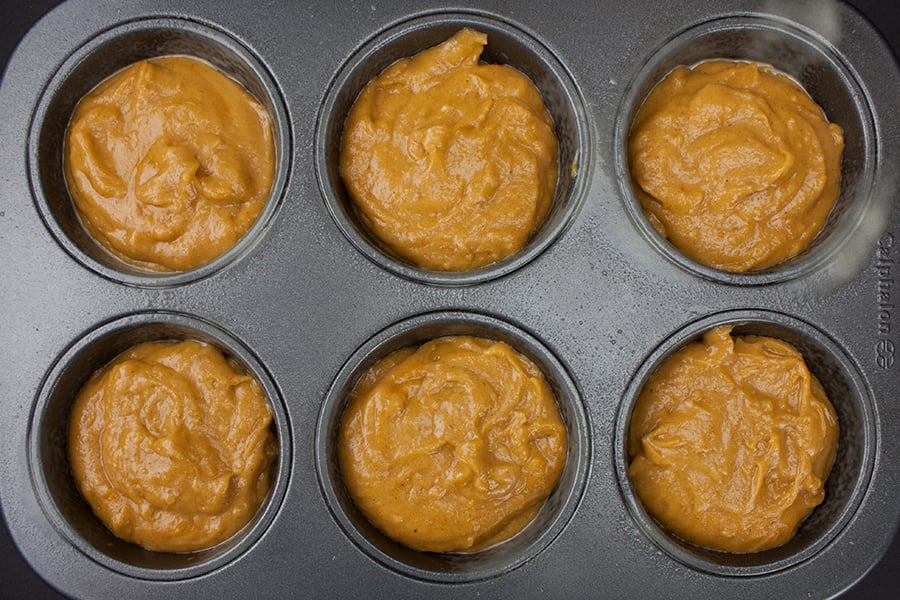 Bakery Style Pumpkin Muffins batter divided into jumbo muffin tin