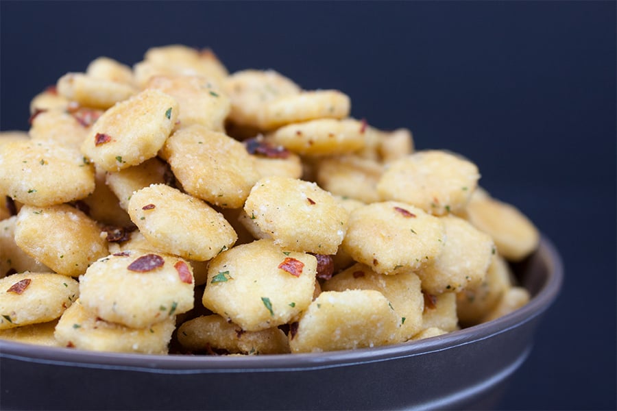 Spicy Seasoned Oyster Crackers in a dark serving bowl.