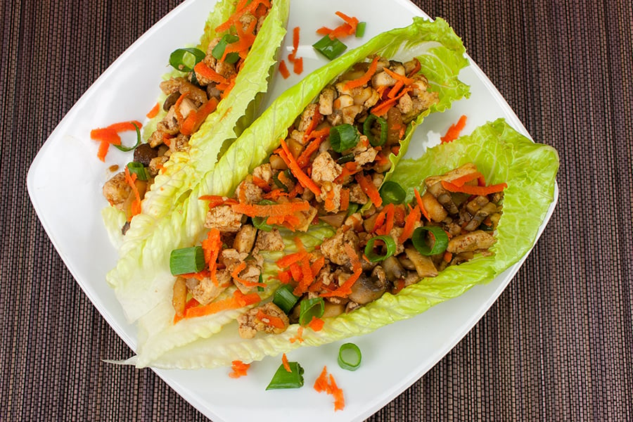 Lettuce wraps on a white plate.