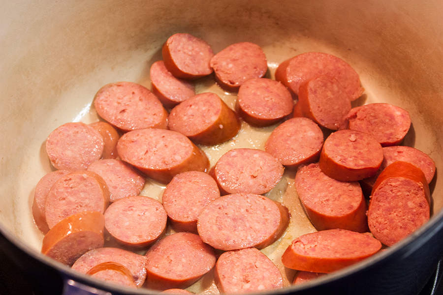 Sausage browning in a dutch oven.