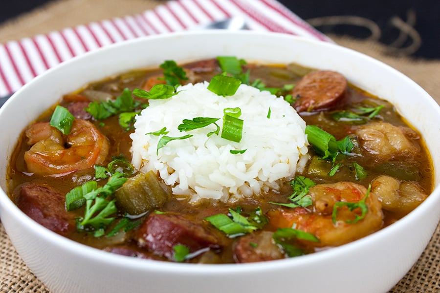 Gumbo and rice in a white bowl.