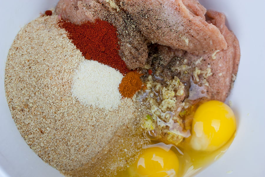 Firecracker chicken meatball ingredients in a large mixing bowl.