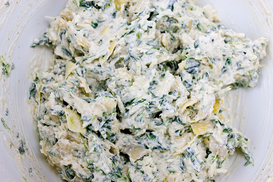 Spinach Artichoke Cups filling combined in a white mixing bowl