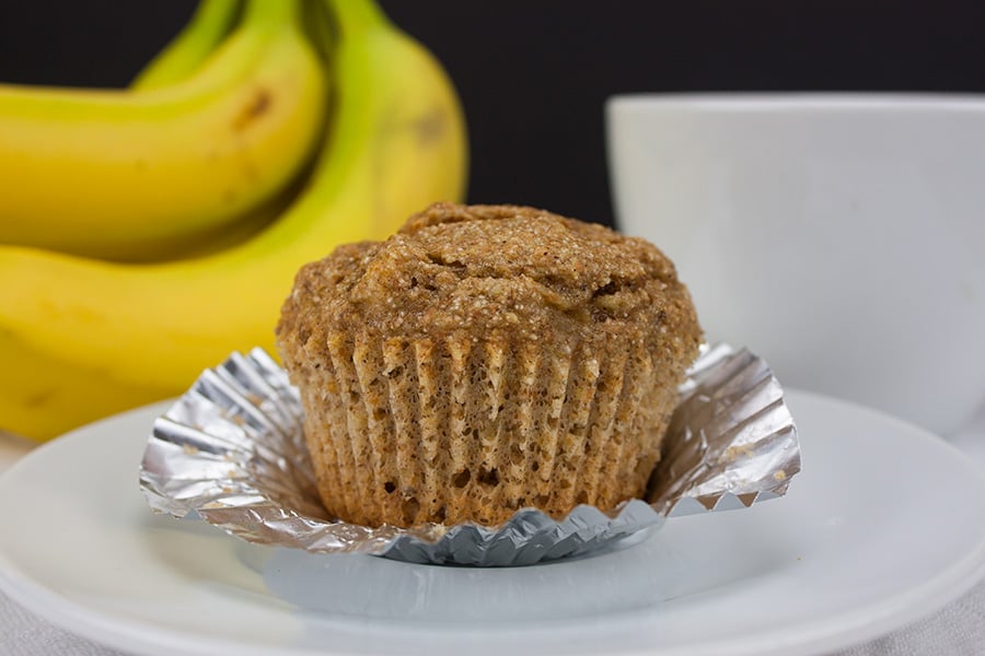 Healthy Whole Wheat Banana Muffin with the cupcake wrapper peeled down.