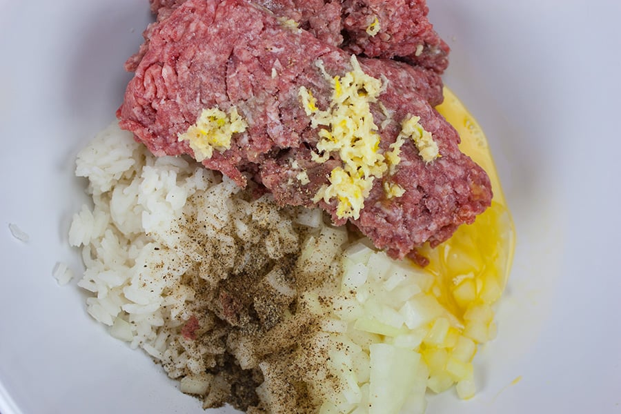 ground beef, rice, and seasonings for easy stuffed cabbage rolls in a white bowl